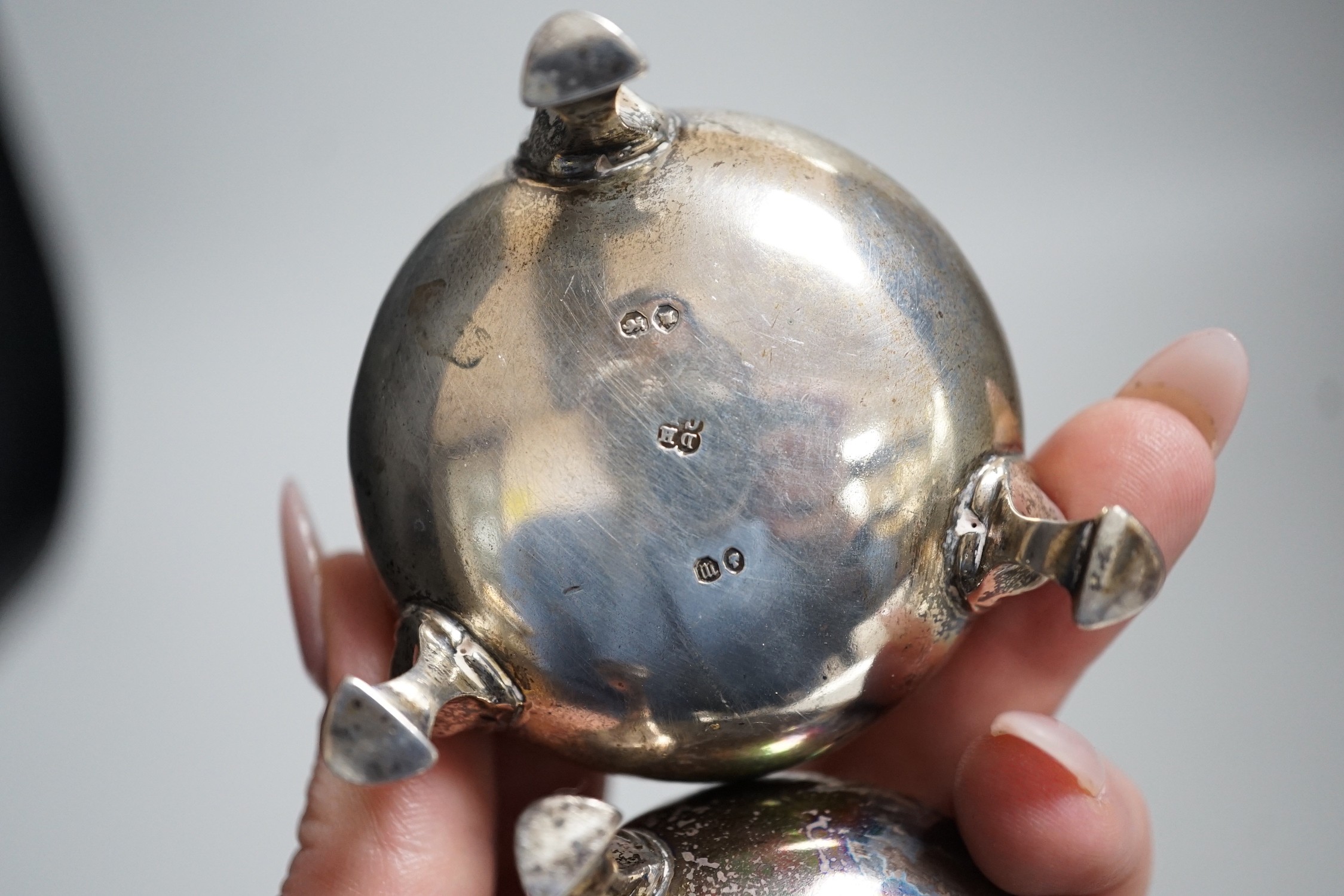A pair of Victorian silver bun salts, London, 1868, diameter 5cm and a pair of Victorian silver peppers.